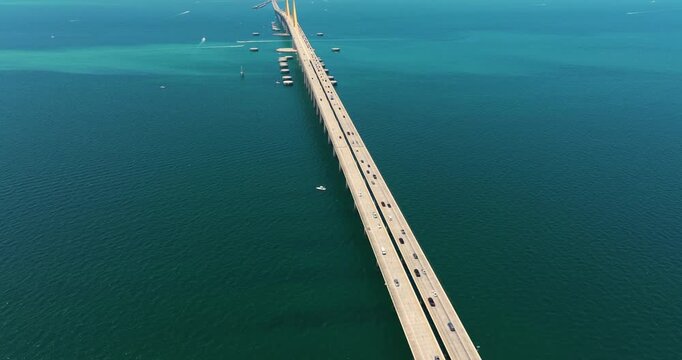 Highway road with driving traffic cars on Sunshine Skyway Bridge over Tampa Bay in Florida. Transportation infrastructure in USA