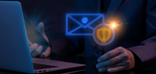 Secure service, protect data, internet safety, firewall system, privacy concept. Businessman working with computer laptop to focus on glowing neon line of electronic mail with protective shield icon.