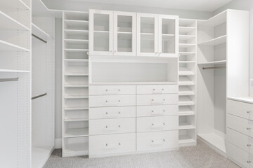 Clean Walk-In Closet With Ample Shelving And Drawer Storage Space