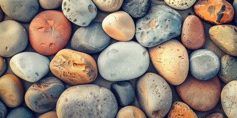 Closeup of various multicolored smooth stones arranged together to showcase their natural beauty and harmonious colors