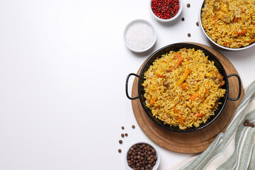 Pilaf and spices on white background, space for text