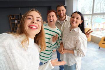Obraz premium Young woman with her friends taking selfie at home, closeup