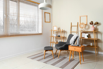 Stylish interior of living room with armchair