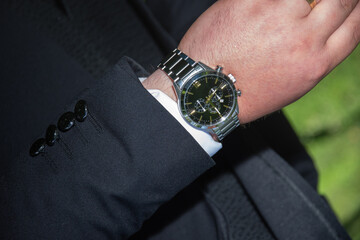 groom suit decorated with accessories, the groom's wristwatch