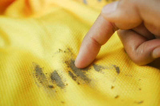  dirty mud stain on a yellow color shirt 