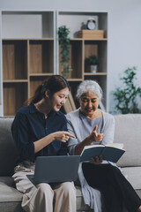 Asian elderly women and friend using social media and living room. Video streaming, happiness and conversation at a house with old people together