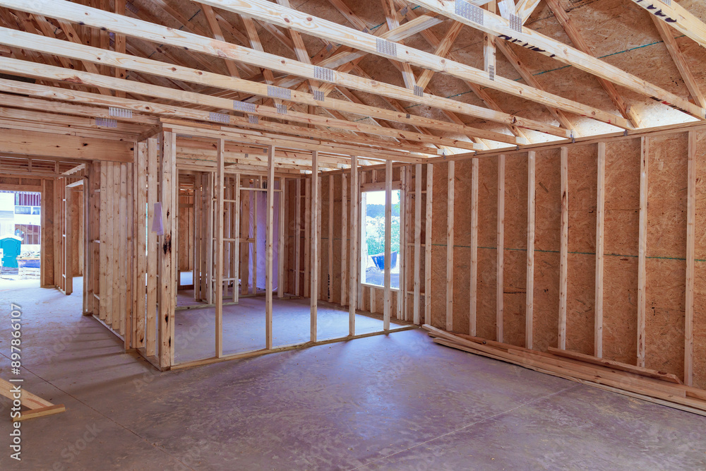 Wall mural framing of new unfinished residential home under construction is made up wood supports beam