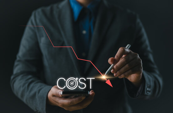 Cost reduction concept. Cost Management, Businessman work on company cost saving. The word 'COST' appears as decrease with down arrow. Economy recession, low budget, Effective business, Expense reduce