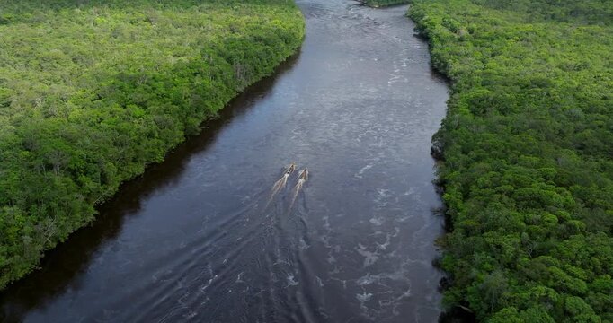Boats Sailing On Churun River Through Vegetation In Canaima National Park, Venezuela. drone arc shot
