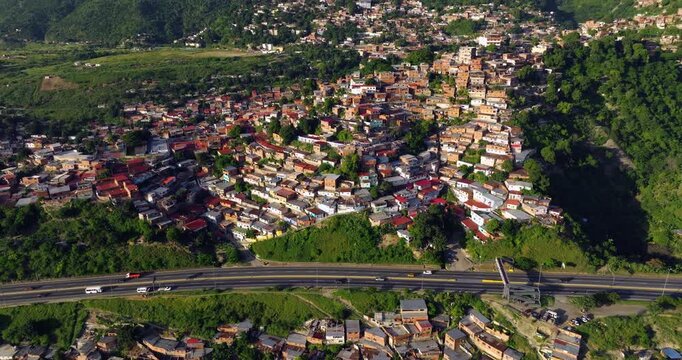 Crowd Of Houses In Favela (Slum) On Hill Near City Of Caracas In Venezuela. aerial shot