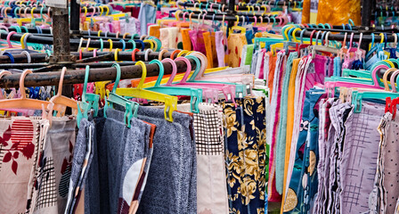 varieties of colorful cloth garments displayed in a fair shop for sale in India