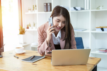 Asian business woman Use a laptop computer and work at the office ready. plan to analyze financial reports