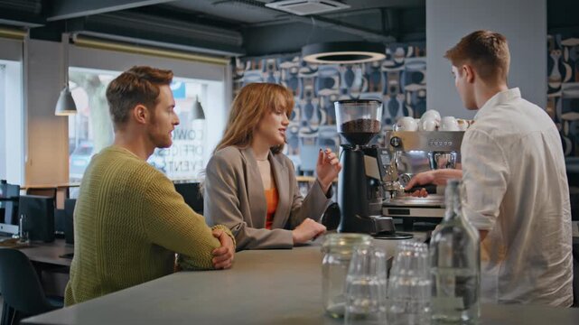 Businesspeople talking bartender ordering coffee at bar. People resting in cafe