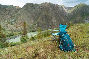 Armchair and backpack in the mountains 