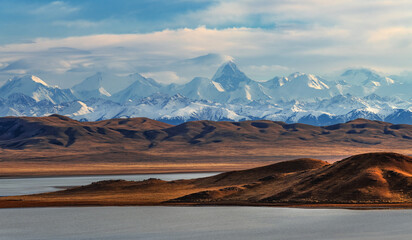 Northern Tien Shan mountain range with Khan Tengri peak in southeast Kazakhstan under a cloudy sky