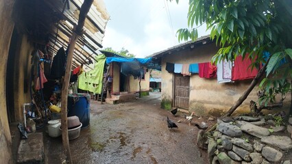  A rural village in Maharashtra during the rainy season with small huts and houses.