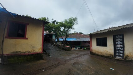  A rural village in Maharashtra during the rainy season with small huts and houses.