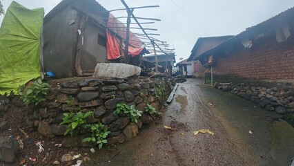  A rural village in Maharashtra during the rainy season with small huts and houses.