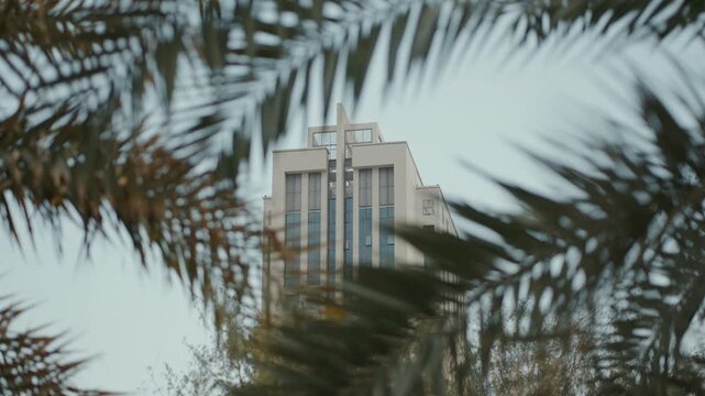 Discover Jumeirah Village Circle in Dubai, featuring modern buildings surrounded by palm trees, creating a serene and picturesque community.