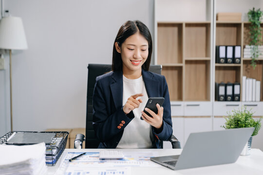 beautiful woman using laptop and tablet while sitting at her working place.