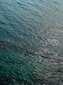 Sea rippled dark blue glittering water surface