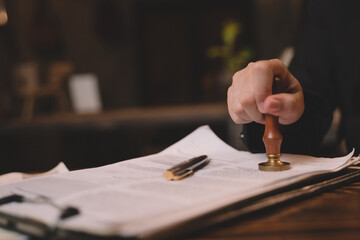 Close-up of a business hand fountain pen and Stamping With Approved On text approved document,...