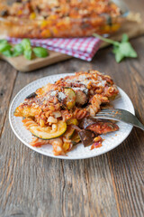 Vegetarian casserole with ratatouille vegetables, pasta, parmesan cheese and pine nuts