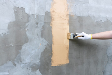 A person is painting a wall with a brush