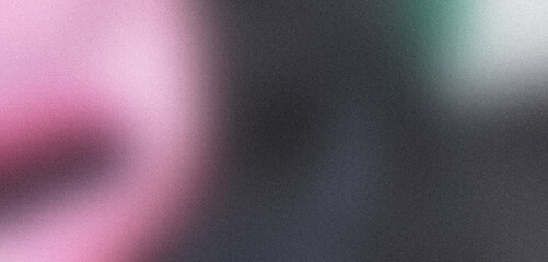Blurred abstract background with grainy texture and pink and green spots