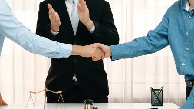Corporate attorney applaud as business people make a successful deal or agreement with handshake, celebrating mutually beneficial acquisition. Business handshaking concept. Slow motion. Rigid.