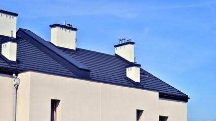 Terraced residential homes with modern facade in newly developed housing estate. The real estate market in the suburbs. New terraced houses in a new development area.