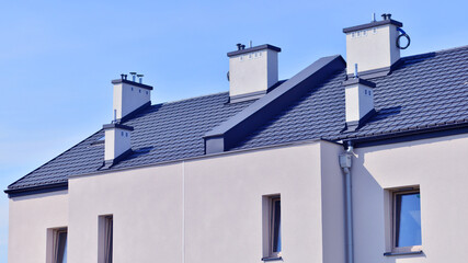 Terraced residential homes with modern facade in newly developed housing estate. The real estate market in the suburbs. New terraced houses in a new development area.