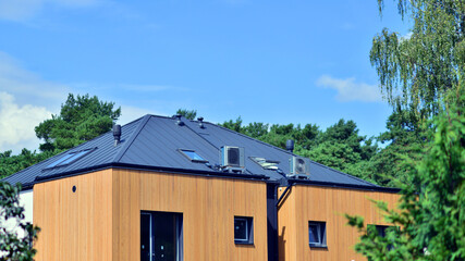 Residential homes with modern wood facade. Terraced family homes in newly developed housing estate. The real estate market in the suburbs.