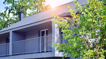 Upscale house in wooded area. Fragment of a single-family house facade. 