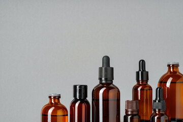 Amber Glass Bottles With Droppers on Grey Background