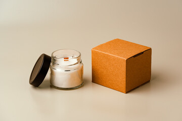 Glass Candle Jar and Cardboard Box on Beige Background