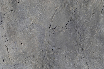 Sea-worn stone texture on a wild coastal beach.