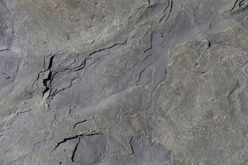 Sea-worn stone texture on a wild coastal beach.