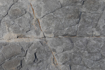 Sea-worn stone texture on a wild coastal beach.