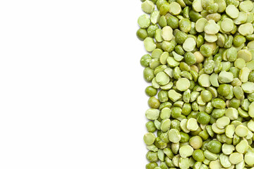 Uncooked, green peas border on white background. Copy space for text. Top view