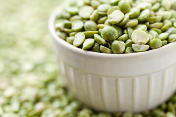 Uncooked, green peas in bowl. Split peas grains