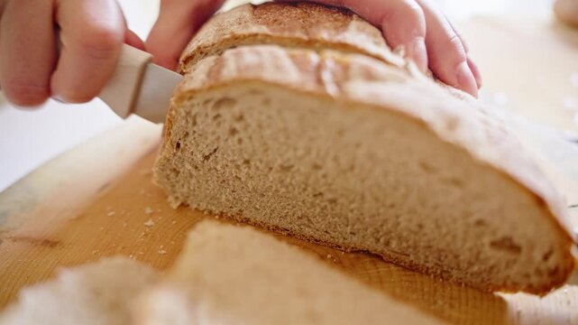 Cutting Fresh Bread in the Kitchen