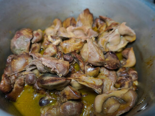 half-cooked chicken liver and gizzards in a pan, in preparation for cooking