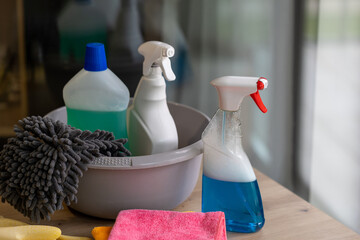 a bucket of cleaning supplies on a table