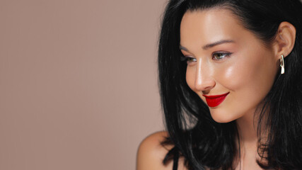 Naklejka premium Elegant Asian Woman with Red Lipstick and Black Hair Posing in Studio