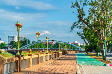 Naklejka premium Route walking jogging or ride bicycle and exercise and Chan Palace Bridge over the Nan River blue sky background New Landmark tourist is Public places Phitsanulok.