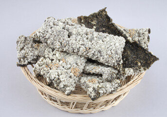 Close-up of Gim-bugak with fried seaweed and glutinous rice on a bamboo basket, South Korea
