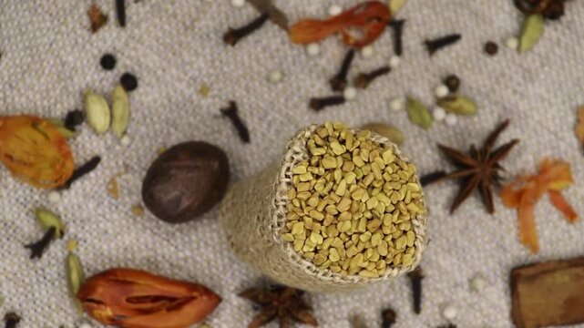 Fenugreek Seeds rotation, close-up. Methi Dana, top view. . Mixed whole Indian spices in background. Mix Colorful Indian Spices. 4k. 