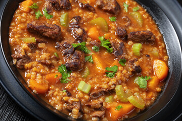 beef barley soup in a bowl, top view