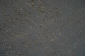 Macro of dusty and weathered dark grey painted wall